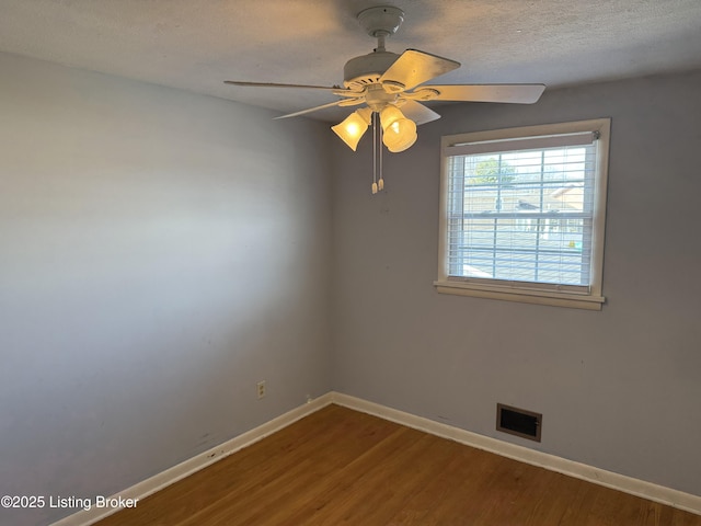 unfurnished room featuring ceiling fan, hardwood / wood-style floors, and a textured ceiling