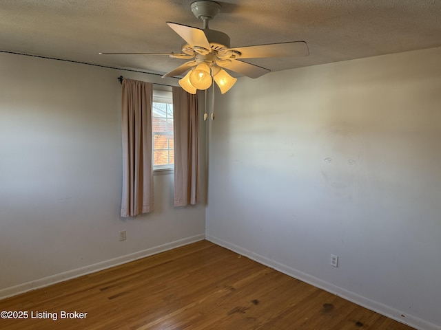 empty room with ceiling fan, hardwood / wood-style floors, and a textured ceiling