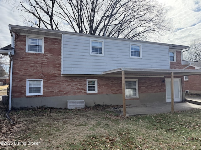 rear view of house featuring a patio area and a lawn