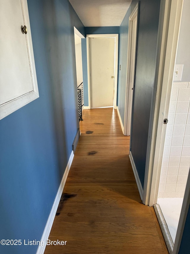 corridor featuring wood-type flooring