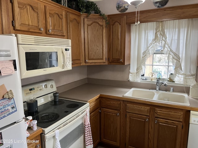 kitchen featuring sink and white appliances