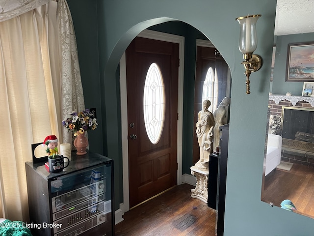 foyer entrance featuring dark hardwood / wood-style floors and a textured ceiling