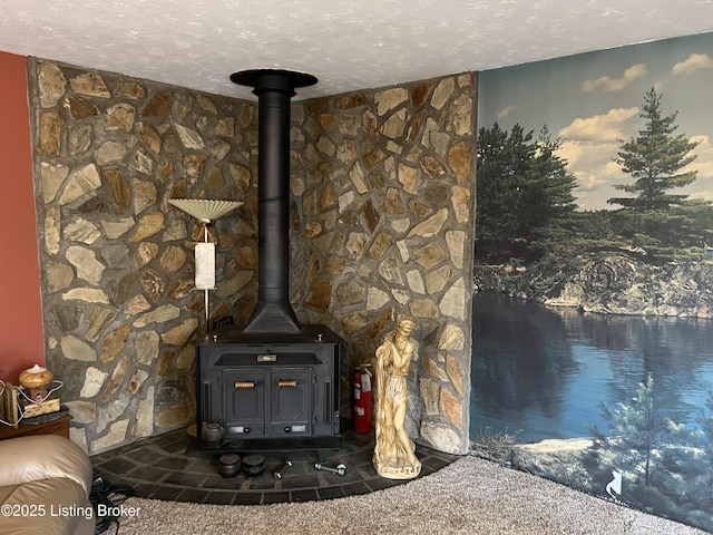 interior details featuring a textured ceiling and a wood stove