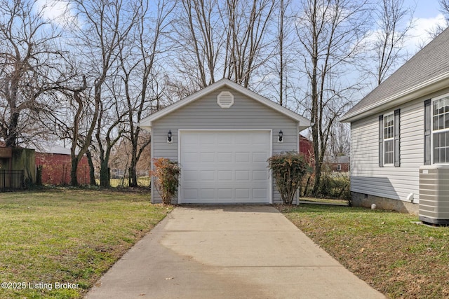 garage featuring central AC unit and a yard