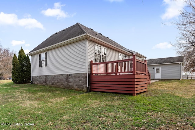 view of side of home with a yard and a deck