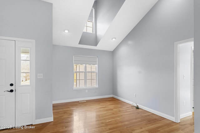 entrance foyer with vaulted ceiling and light wood-type flooring