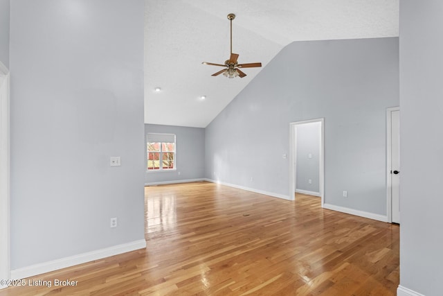 unfurnished living room featuring ceiling fan, high vaulted ceiling, and light hardwood / wood-style floors