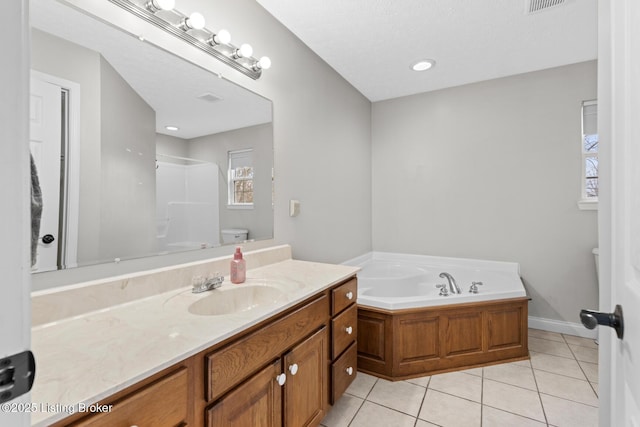 full bathroom with vanity, toilet, tile patterned flooring, and plus walk in shower