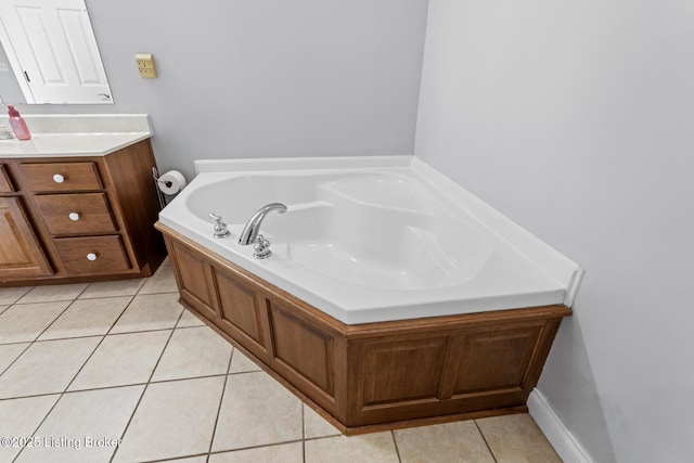 bathroom featuring vanity, a bathtub, and tile patterned floors