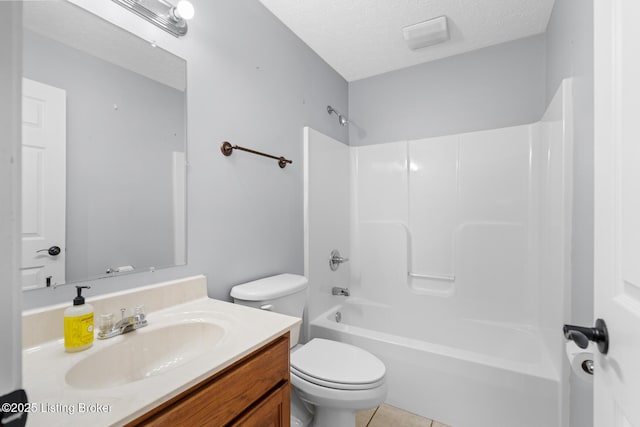 full bathroom with shower / bath combination, vanity, tile patterned flooring, toilet, and a textured ceiling