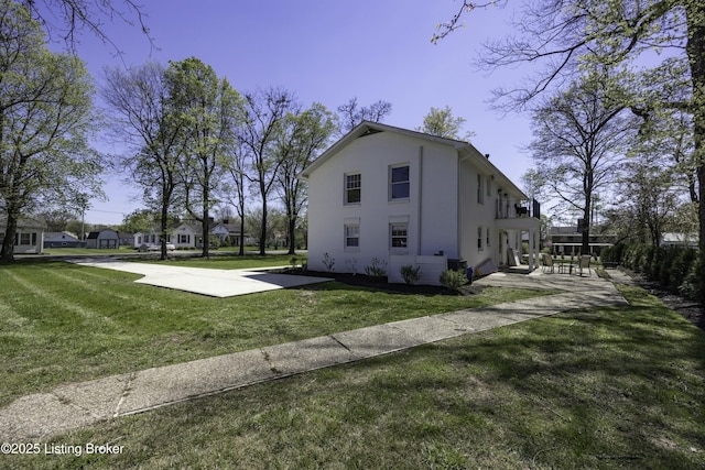 view of side of home with a yard