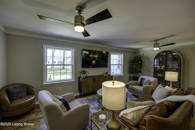 living room with crown molding, ceiling fan, and hardwood / wood-style floors