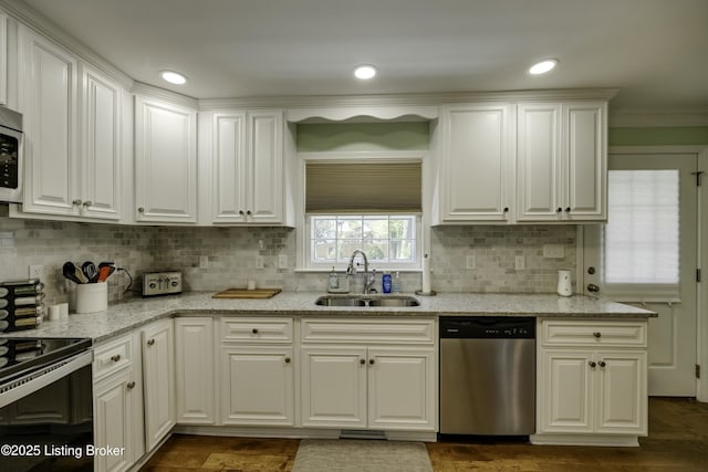 kitchen with white cabinetry, dishwasher, sink, and light stone countertops