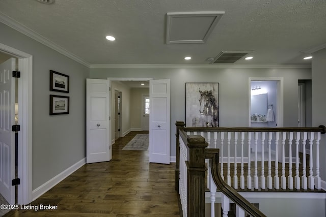 corridor with dark hardwood / wood-style flooring, crown molding, and a textured ceiling