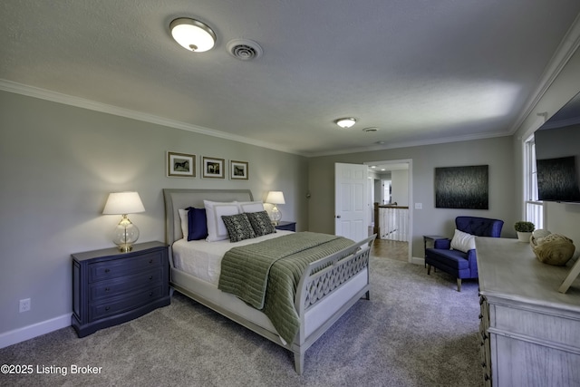 bedroom with ornamental molding, a textured ceiling, and carpet