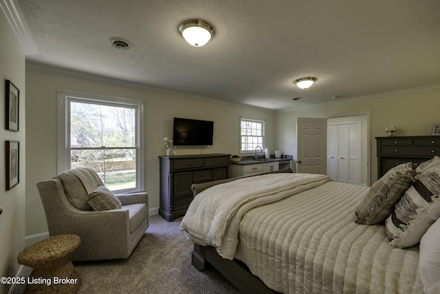 bedroom with light carpet, sink, ornamental molding, and a textured ceiling