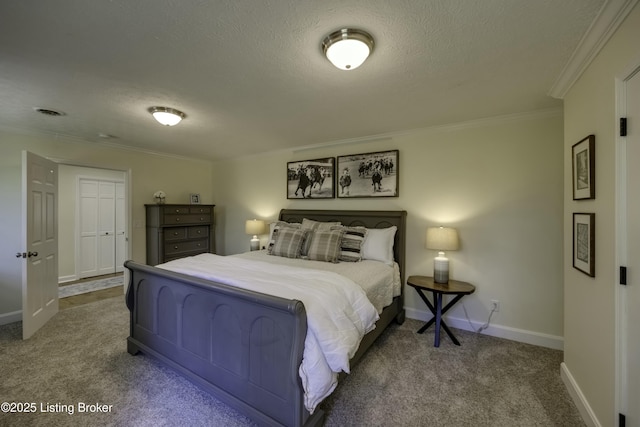 carpeted bedroom with ornamental molding and a textured ceiling