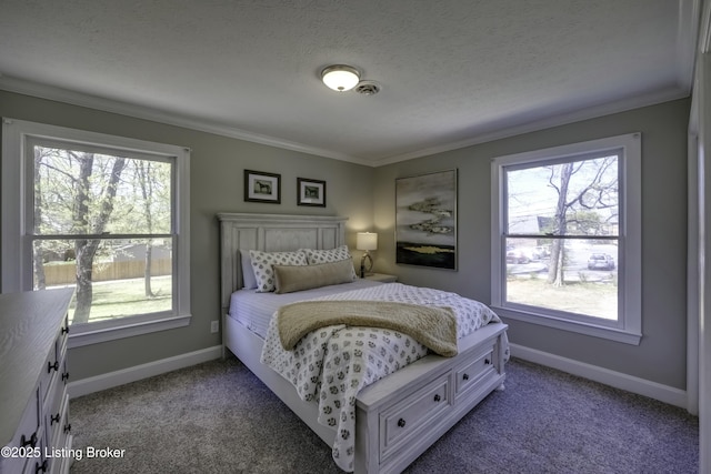 bedroom with crown molding, carpet floors, and a textured ceiling