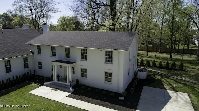 view of front of property with a front yard and central air condition unit