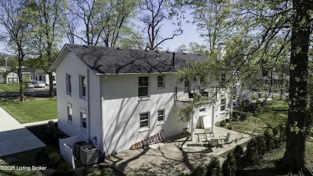 exterior space with central AC, a yard, and a patio