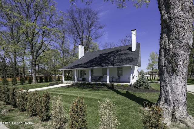 view of front of property with covered porch and a front yard