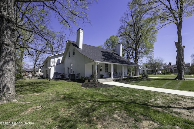 view of home's exterior featuring cooling unit, covered porch, and a lawn