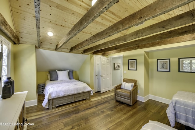 bedroom with beam ceiling, dark wood-type flooring, and wooden ceiling