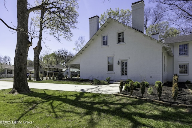 view of side of property with a yard