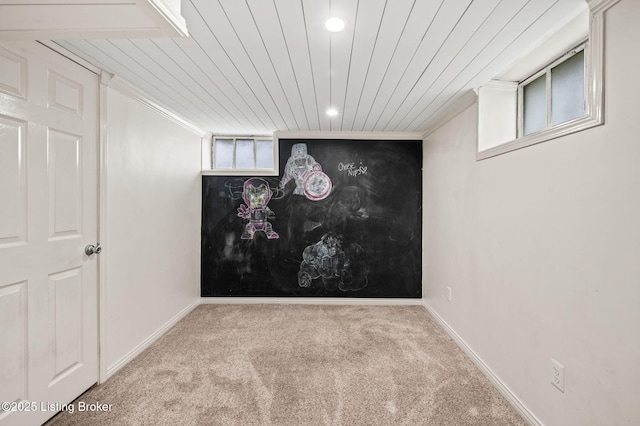 basement featuring light carpet and wooden ceiling