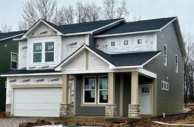 view of front facade with a garage and covered porch