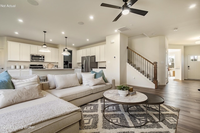 living room featuring dark hardwood / wood-style flooring, sink, and ceiling fan