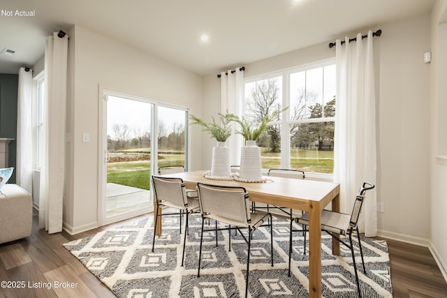 dining room with dark hardwood / wood-style flooring