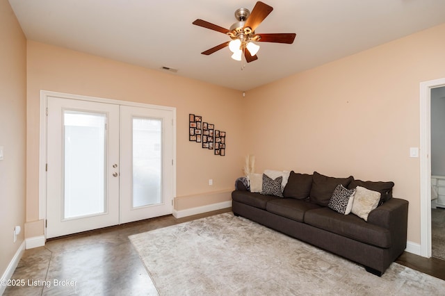 living room featuring ceiling fan and french doors