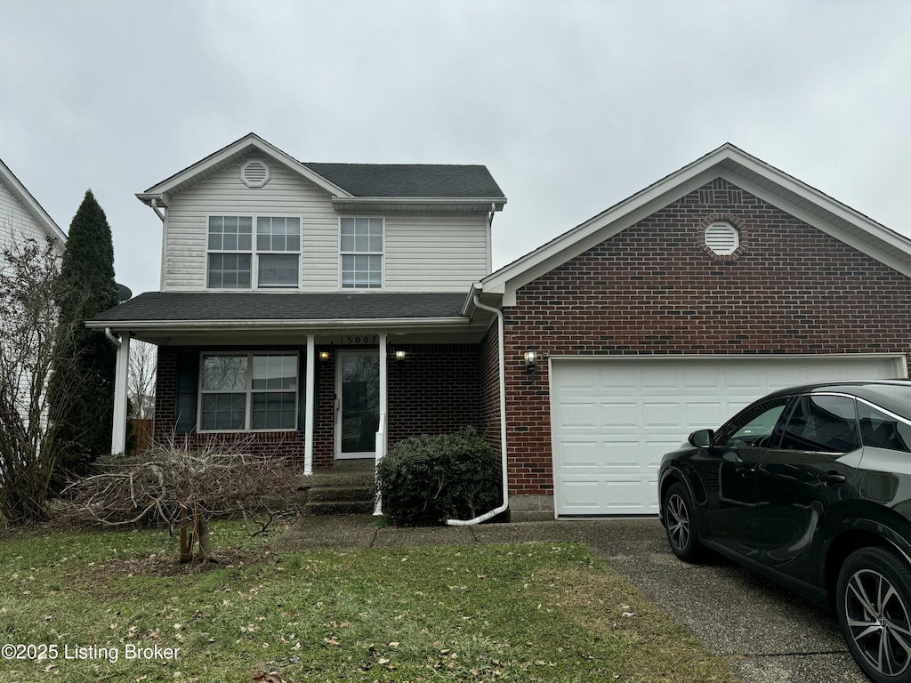 front facade with a garage and a front yard