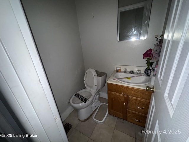 bathroom with vanity, tile patterned floors, and toilet