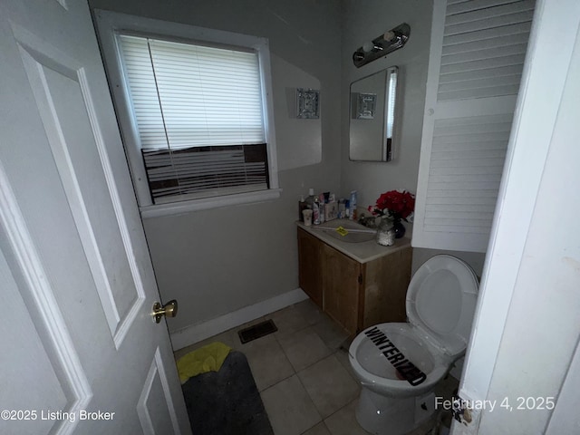 bathroom featuring vanity, toilet, and tile patterned flooring