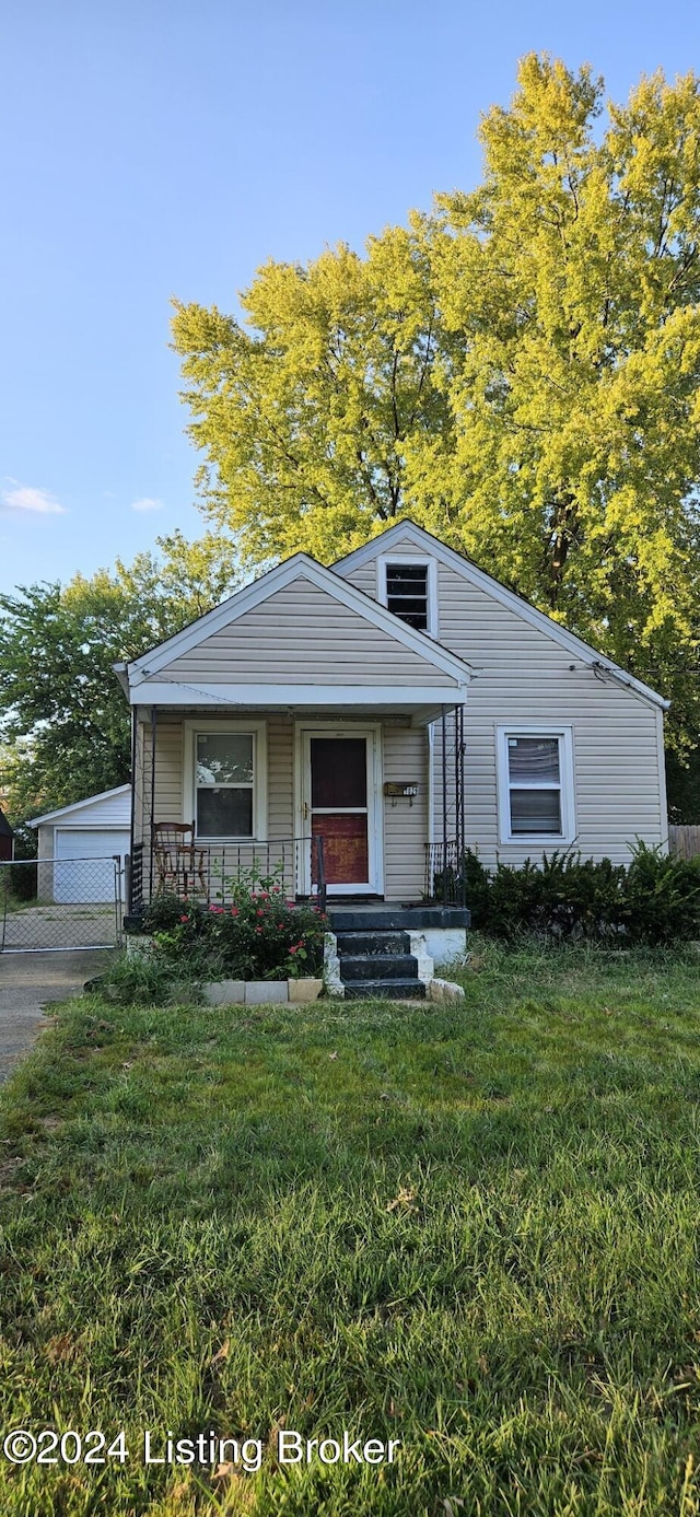 view of front facade featuring a garage, covered porch, and a front lawn