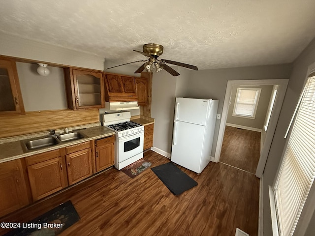 kitchen featuring sink, white appliances, dark wood-type flooring, ceiling fan, and a textured ceiling