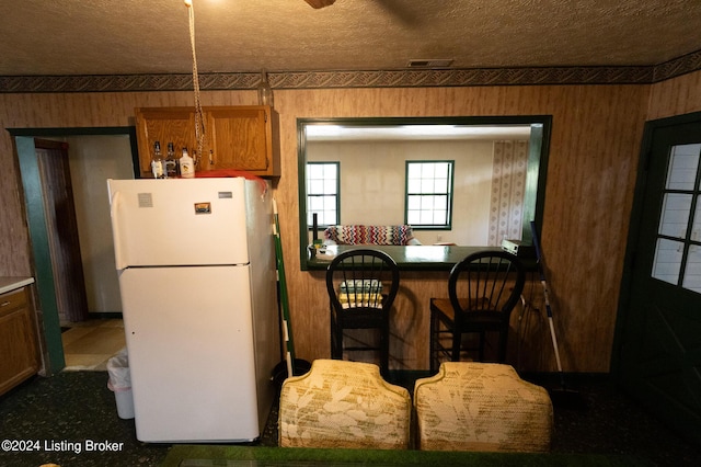 kitchen featuring white fridge and a textured ceiling