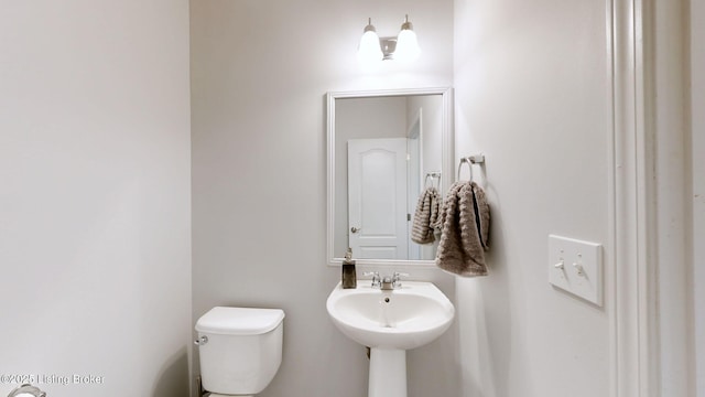 bathroom featuring sink and toilet