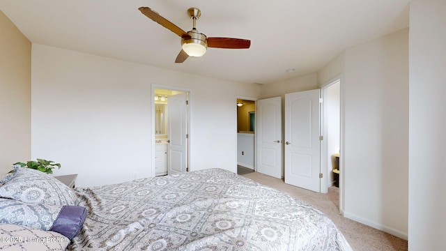 carpeted bedroom featuring ceiling fan and ensuite bath