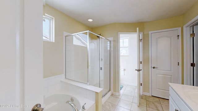 bathroom with vanity, a healthy amount of sunlight, and separate shower and tub