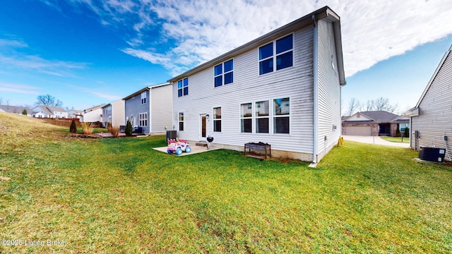 rear view of property featuring a yard, a patio, and central air condition unit