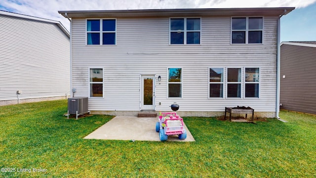 back of property with central AC, a patio, and a lawn