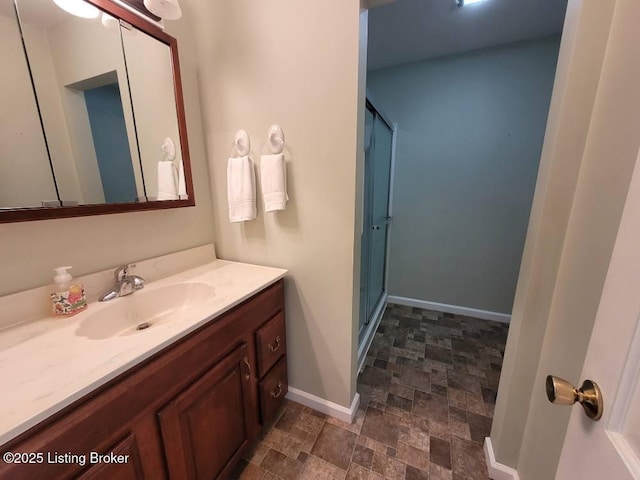 bathroom with vanity and a shower with shower door