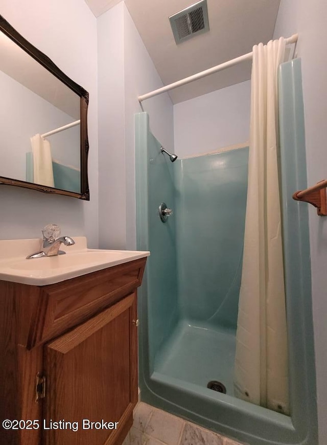 bathroom featuring vanity and a shower with shower curtain