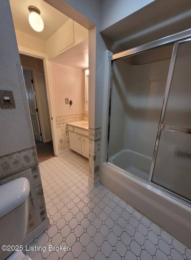 full bathroom with vanity, combined bath / shower with glass door, and toilet