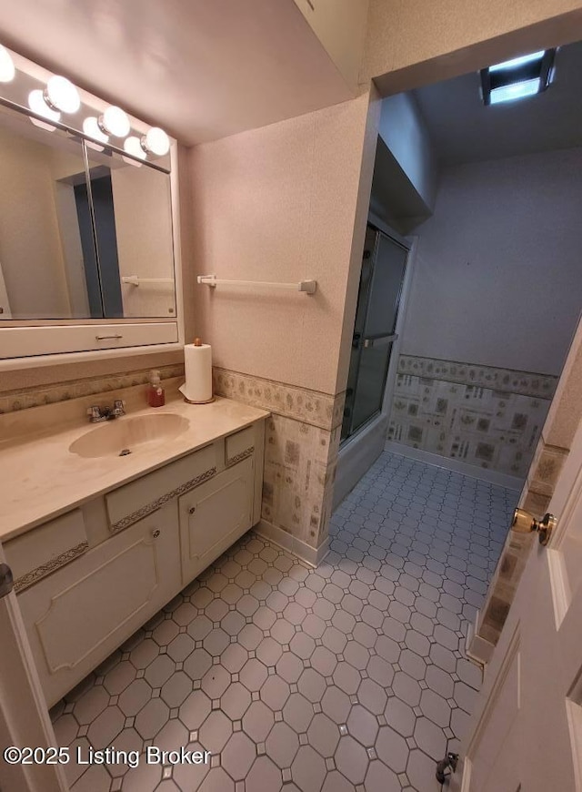 bathroom featuring walk in shower and vanity