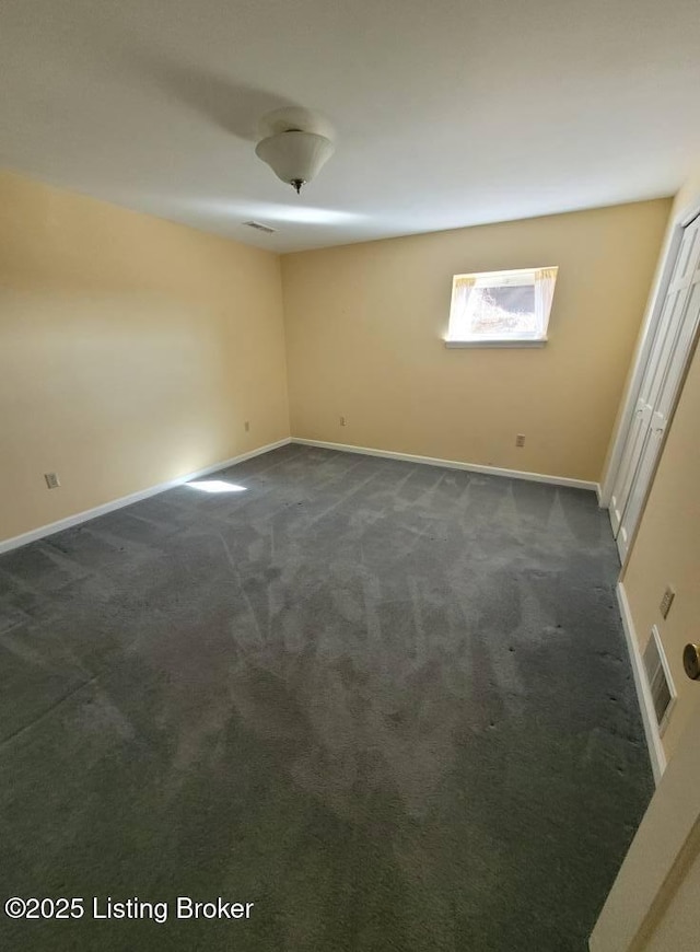 empty room with dark carpet