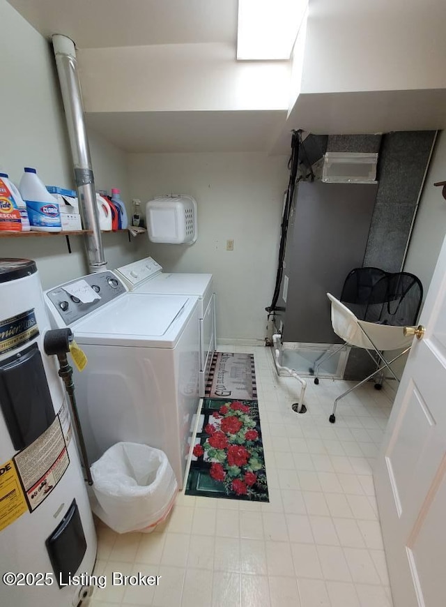 clothes washing area with washing machine and clothes dryer and electric water heater